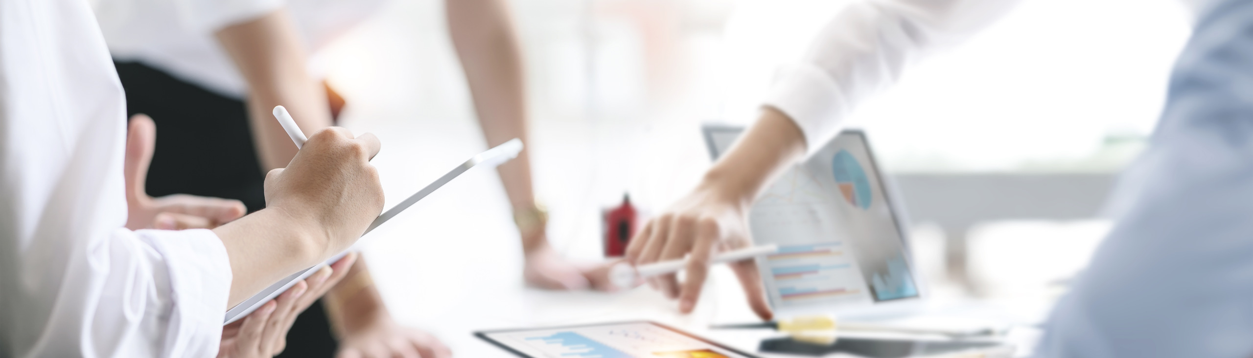 Cropped shot of diverse coworkers working together in boardroom,